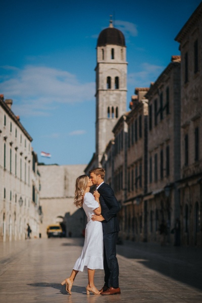 Portrait of a couple at Stradun main Street in the Old town of Dubrovnik, morning light