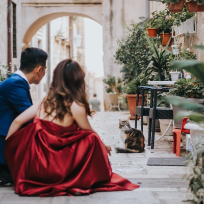 Hidden corners in the Old town of Dubrovnik, lovely couple looking at the cat