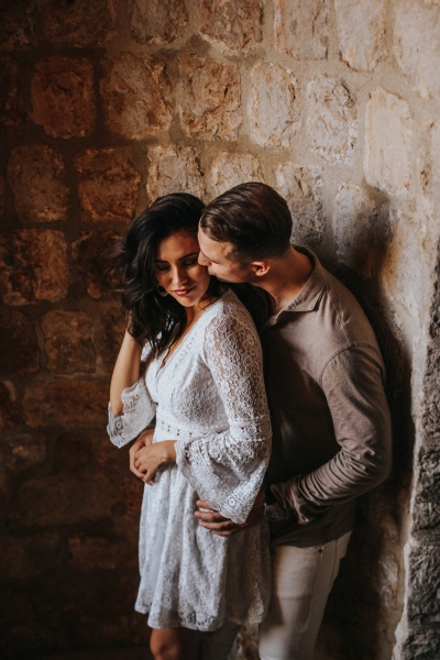 Romantic photo of a couple at st. Lawrence fortress in Dubrovnik during the morning couple photo shoot. Low light, art