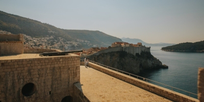 St. Lawrence fortress in Dubrovnik, panoramic view over the Old town in the morning. Couple on a photo shoot