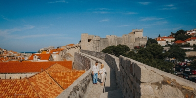 Dubrovnik City Walls in the morning, Old town red roofs and  Minceta tower in the background. Photo shoot with a beautiful couple. Maternity, Game of Thrones