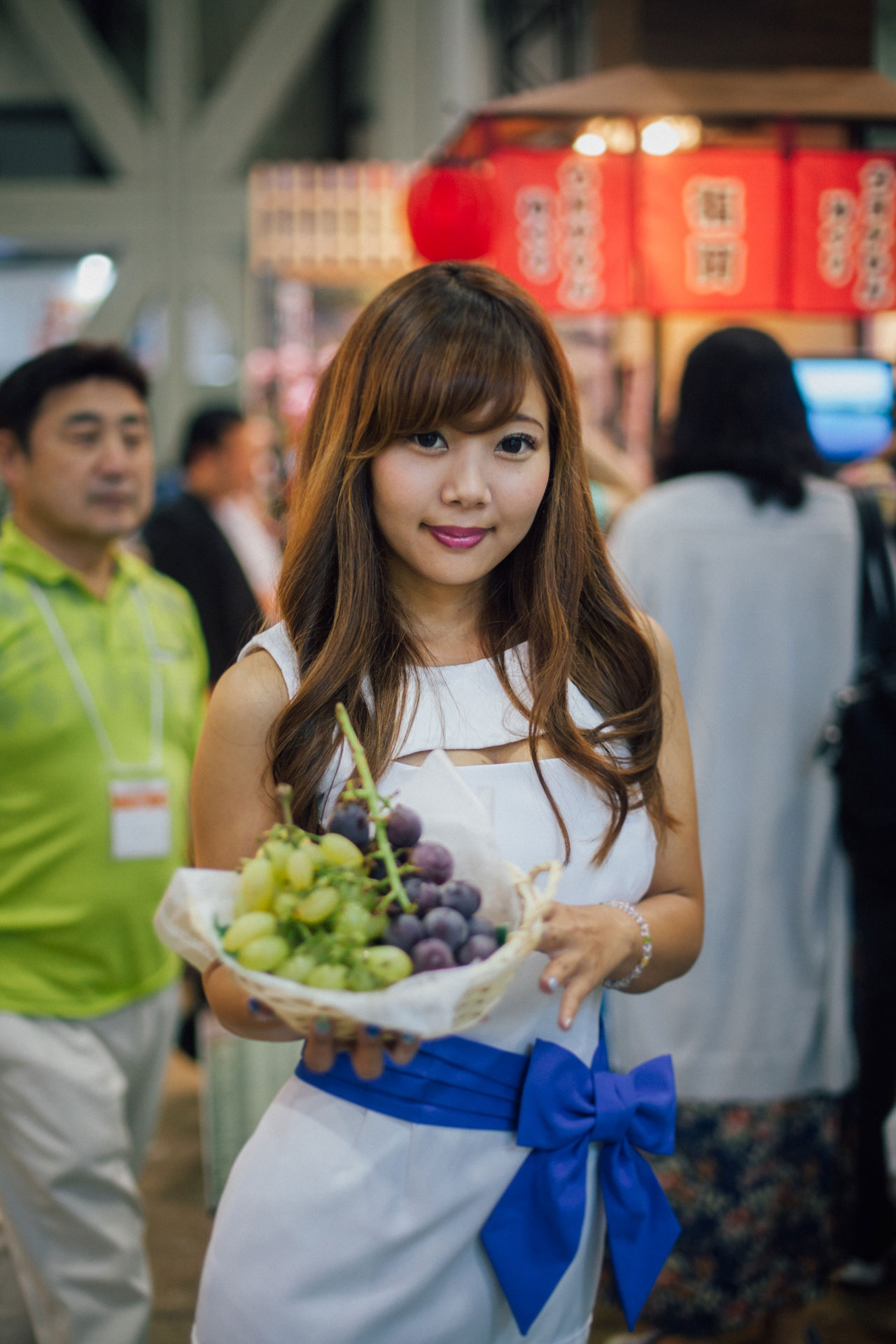 Girl from Japan holding grapes